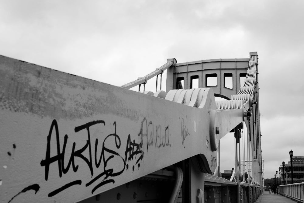 Graffiti on a bridge with a cloudy sky