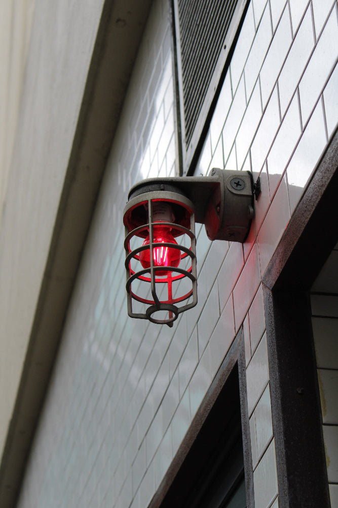 Red fire alarm light on a building exterior